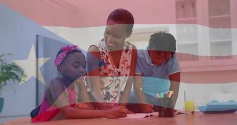 Mother guiding children doing homework at kitchen table with patriotic flag overlay