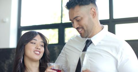 Elegant african american couple toasting and smiling at daytime gala reception in lounge