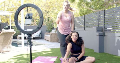 Outdoor stretching session with instructor by poolside