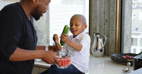 Father and Son Bonding While Cooking in Modern Kitchen