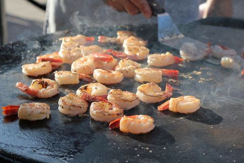 Grilling shrimp outdoors on a flat top grill