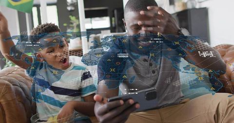 Father and son reacting to smartphone with global network overlay, family tech bonding at home