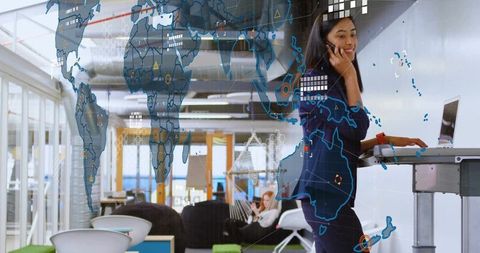 Asian Woman at Standing Desk with Digital Map Display, Modern Office