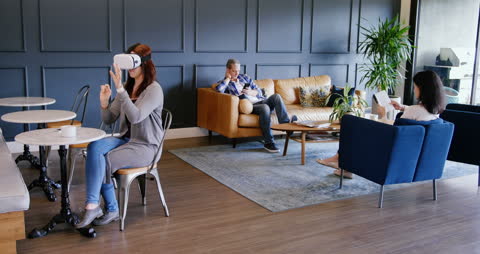 Business Professionals Embracing Technology in Modern Lobby