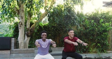 Diverse Male Friends Exercising Outdoors with Smartwatches