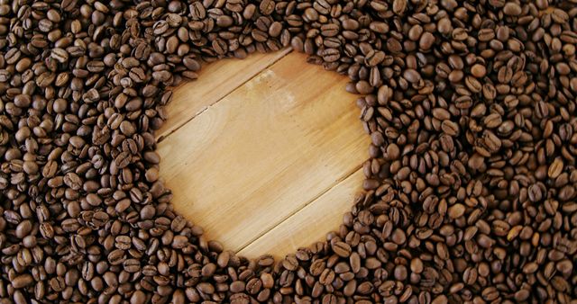 Coffee beans are arranged in a circular pattern around a wooden surface, with copy space. The image captures the rich texture of the beans, ideal for themes related to coffee, energy, and gourmet experiences.