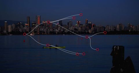 Connected Cityscape Overlooking Tranquil Sea during Nightfall