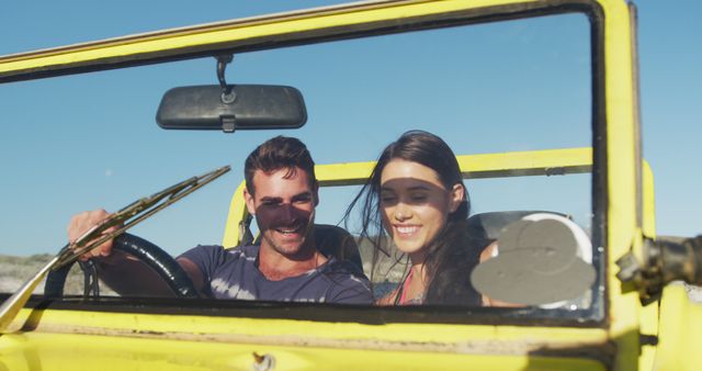 Happy caucasian couple sitting in beach buggy by the sea using smartphone - Download Free Stock Photos Pikwizard.com