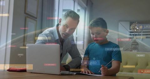Father tutoring son at home with laptop showing online learning and social media overlays