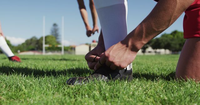 Athletic Man Tying Soccer Shoe on Field Before Game - Download Free Stock Images Pikwizard.com