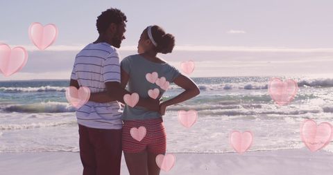 Romantic Couple Embracing on Sunny Beach with Hearts