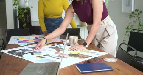 Creative team collaborating over moodboard and color swatches for branding project