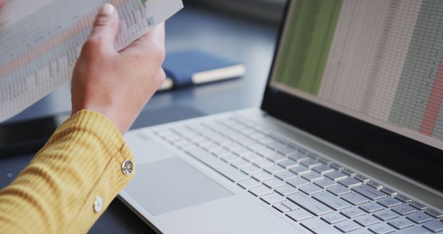 Close-up of person working with financial documents and laptop - Download Free Stock Images Pikwizard.com