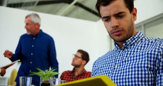 Focused Office Employee Reviewing Documents During Team Meeting - Download Free Stock Images Pikwizard.com