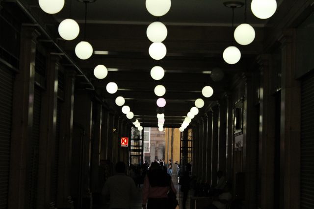 Dimly Lit Corridor with Globe Lights and Columns - Download Free Stock Photos Pikwizard.com
