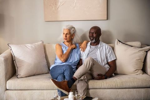 Mature Couple Relaxing on Sofa in Stylish Living Room