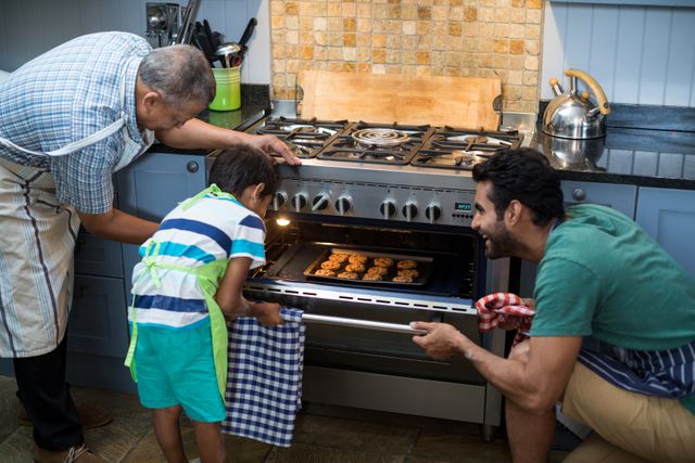 Family keeping cookies in oven at home