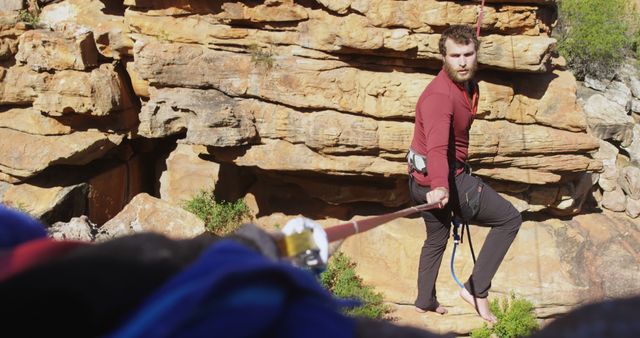 Man Rock Climbing with Rope on Rocky Site - Download Free Stock Images Pikwizard.com