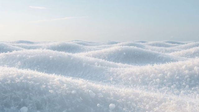 Crystalline snow dunes stretching to horizon under pale winter sky, sparkling frost ridges