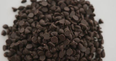 Close-Up of Rich Dark Chocolate Chips on White Background
