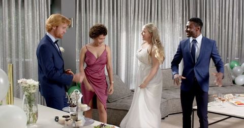 Celebrating wedding reception with friends indoors