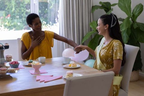 Diverse Friends Celebrating with Tea and Pastries at Home
