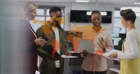 Diverse Team Collaborating Over Global Data Presentation in Office