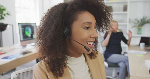 Enthusiastic Businesswoman on Headset in Modern Office