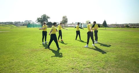 Diverse Team Stretching in Sports AmUniform Park