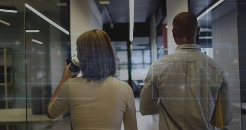 Coworkers Collaborating in Futuristic Office Environment
