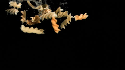 Cooking Concept Animated Paste Falling into Water on Black Background
