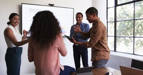 Diverse Team Enthusiastically Collaborating in Office Meeting