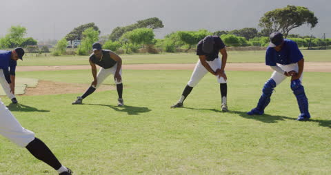Diverse Baseball Team Stretching During Practice