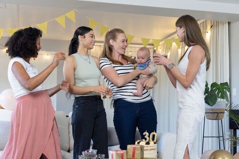 Diverse Group of Women Celebrating Birthday with Baby in Living Room