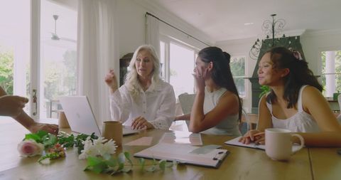 Diverse Women Collaborating on Wedding Plans in Bright Room