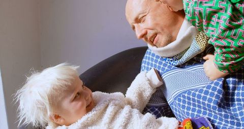 Caucasian Father Bonding with Children in Cozy Living Space