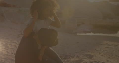 Couple at Beach Relaxing Together in Sunset Glow