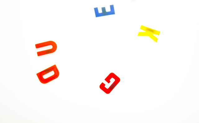 Various colorful alphabet letters scattered on a plain white background. Great for use in child education materials, playful typography designs, or as educational tools for kids. The bright colors give a fun and engaging look suitable for early childhood learning environments and school projects.