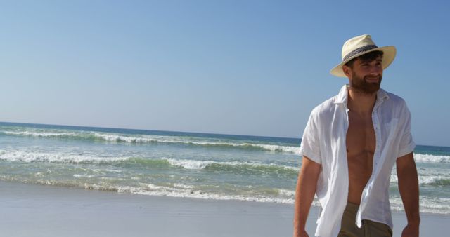 Smiling Man in Straw Hat Walking on Sunny Beach - Download Free Stock Images Pikwizard.com