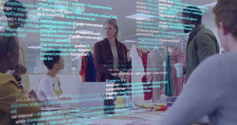 Blonde Woman Leading Fashion Design Team Meeting Reviewing Garments, Swatches, Sketches