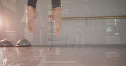 Midair ballet leap pointed toes bare feet black leggings barre studio fitness hud