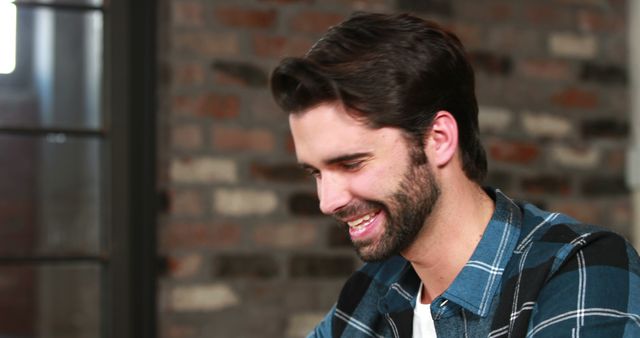 Smiling Man in Casual Attire Relaxed at Brick Wall Background - Download Free Stock Images Pikwizard.com