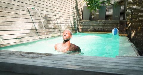 Man Enjoying Refreshing Plunge Pool on Sunny Day