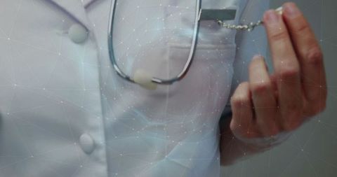 Healthcare professional holding retractable badge in clinic
