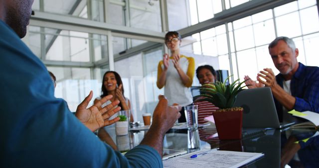 Diverse business professionals celebrate a success in a modern office environment, with copy space - Download Free Stock Photos Pikwizard.com