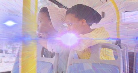 Two women with special effects light beam on bus journey
