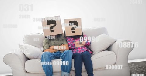 Anonymous Couple Seated with Mystery Question Marks on Boxes