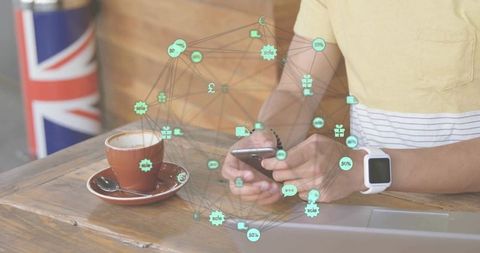 Using smartphone at cafe with smartwatch and union jack flag, augmented network overlay