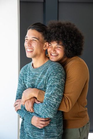 Affectionate Two Men Embracing in Cozy Home Entryway