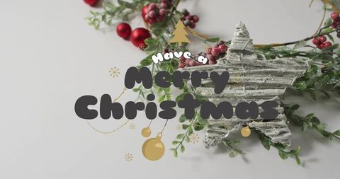 Merry christmas typography flatlay featuring frosted corrugated star and red berries
